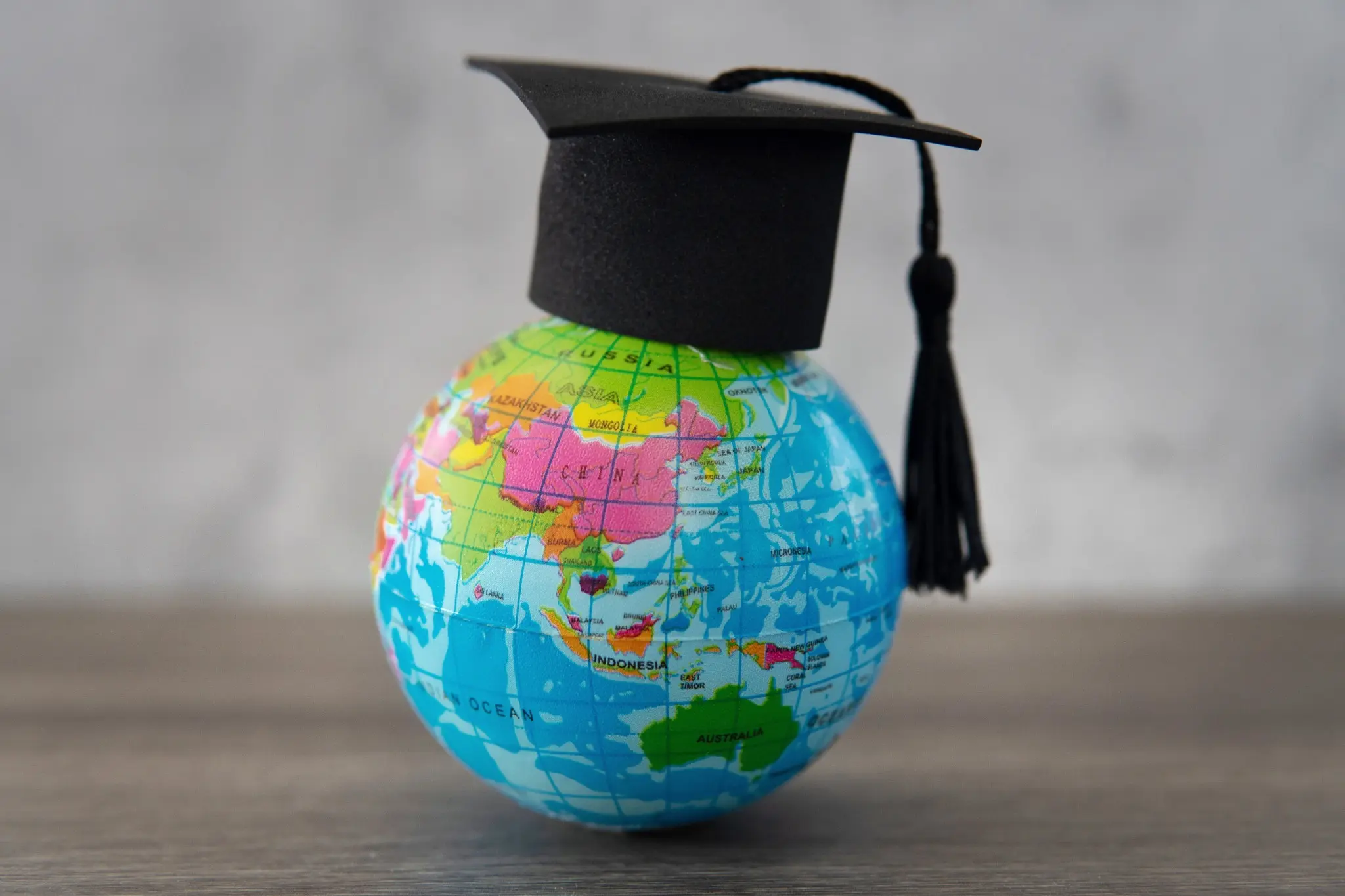 Graduation cap on a globe representing international education opportunities with GloboPrime Overseas Education Consultants in Chennai